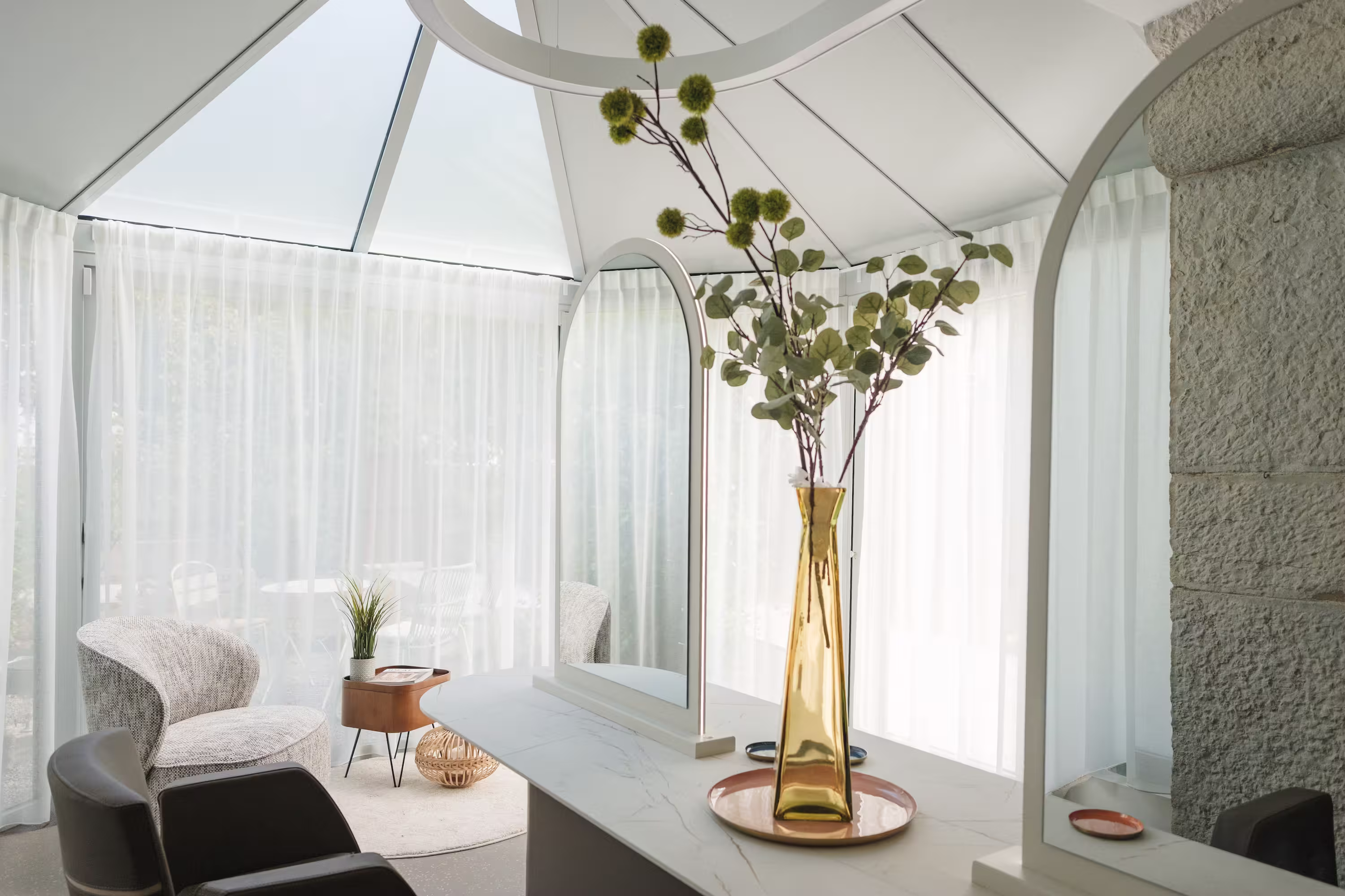 Reception desk with giraffe-shaped lamp in a modern salon featuring hair products and jewelry displays.